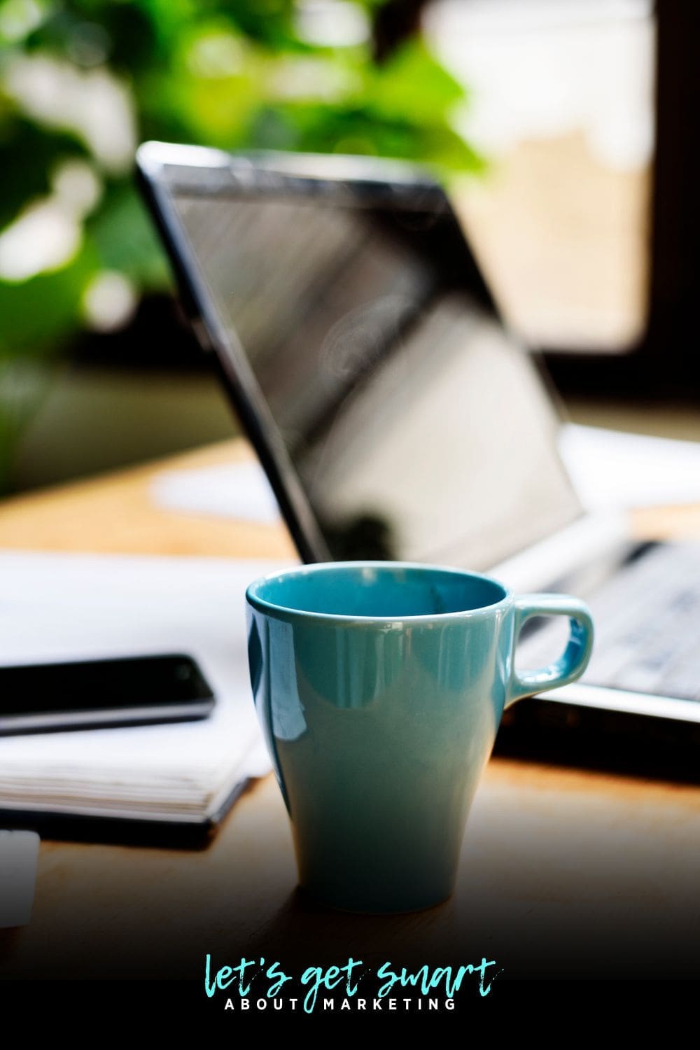 Coffee cup next to laptop 